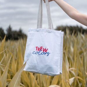 a hand holding a tote bag